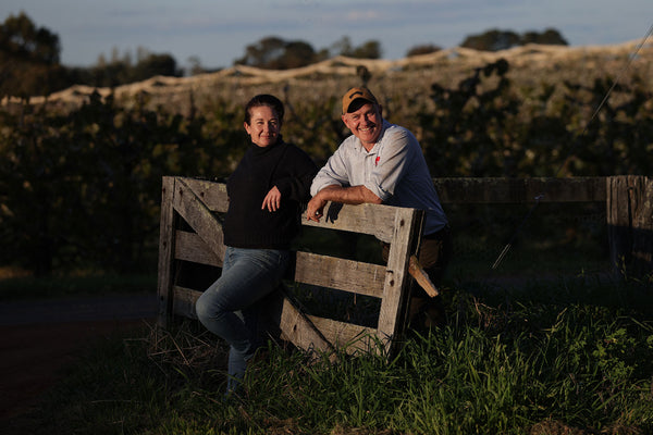 Fiona and Bernard Hall - BiteRiot! owners, standing at the farm gate